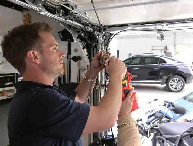Wrentham Garage Door Repair safety certified technician performing cable replacement in Wrentham